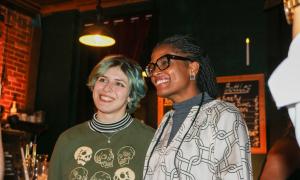 Two women smile at the camera