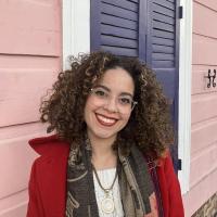 Curly hair woman smiling.