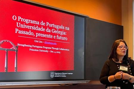 Dr. Lira stands in front of her presentation slide. 