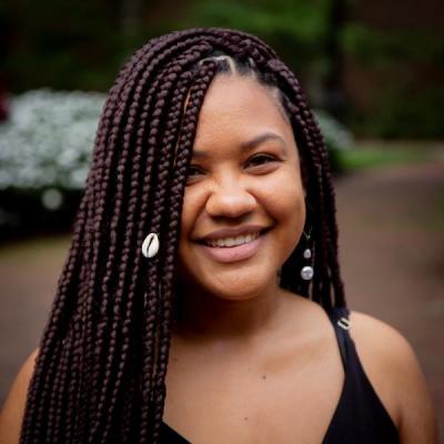 Afro Brazilian woman with braids smiling to the camera